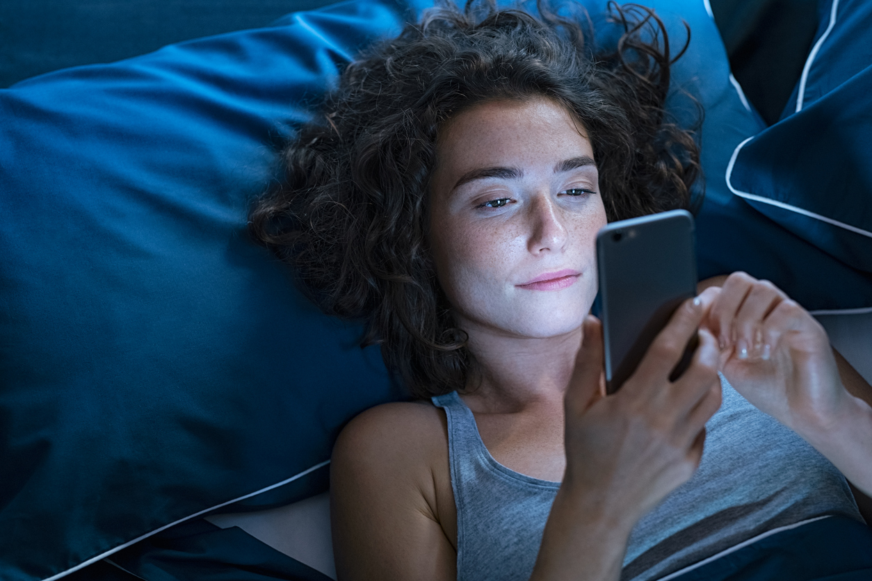 woman using her phone in the dark