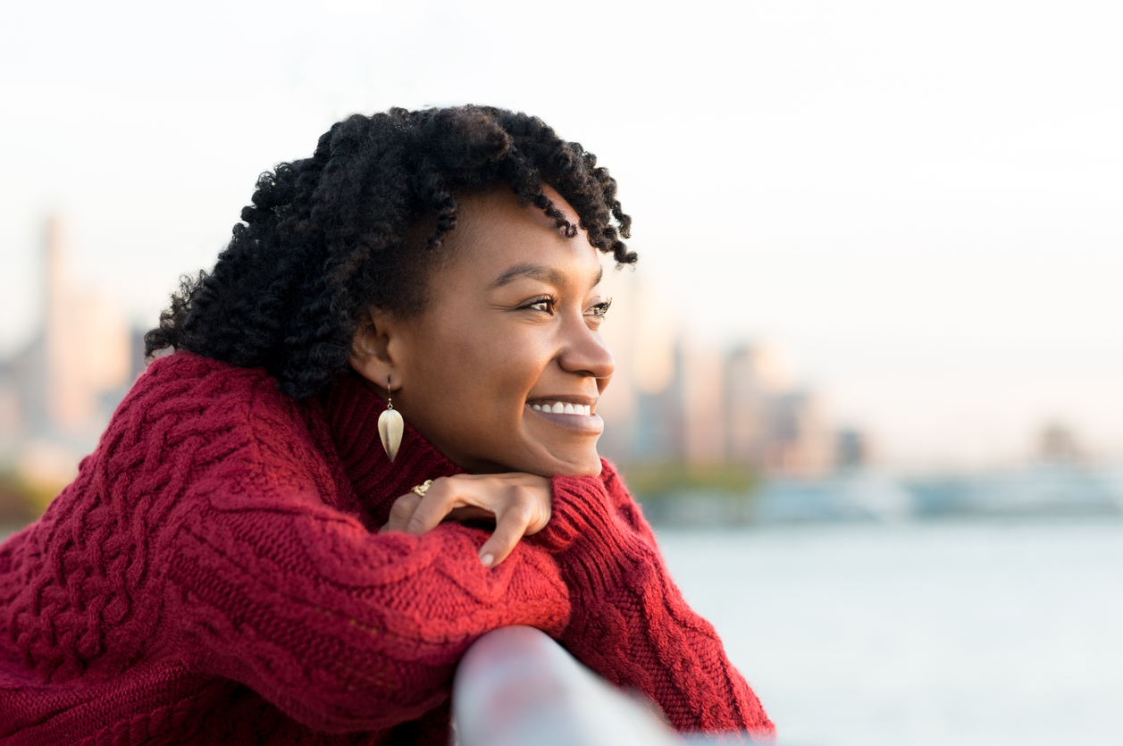 happy woman staring out at the water