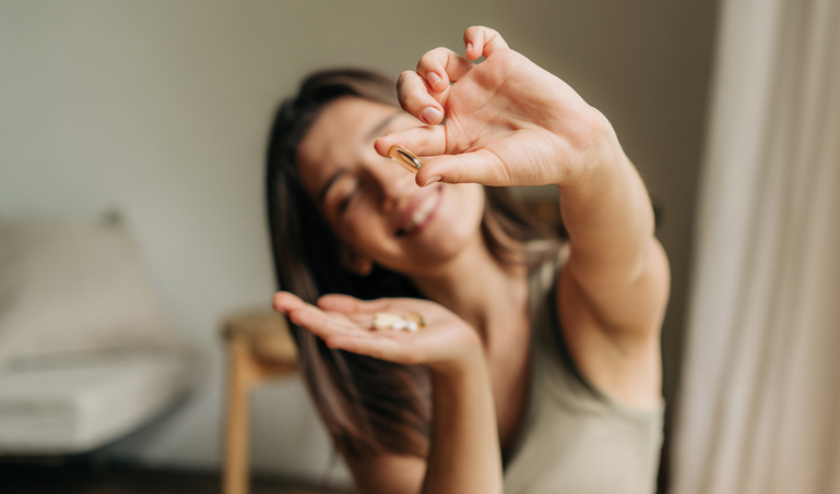 woman counting out her prenatal vitamins