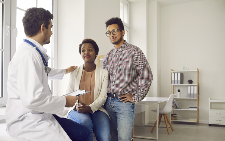doctor discussing ivf insurance coverage options with couple