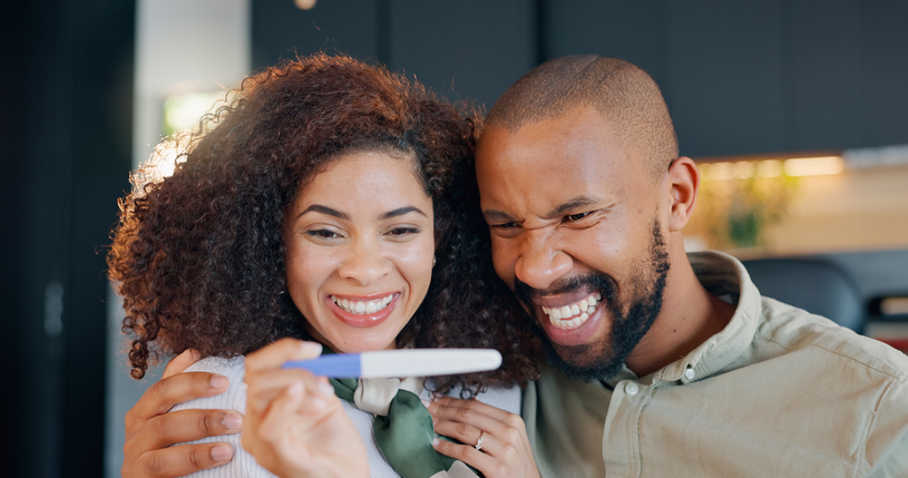 couple excited about positive pregnancy test after ivf treatment