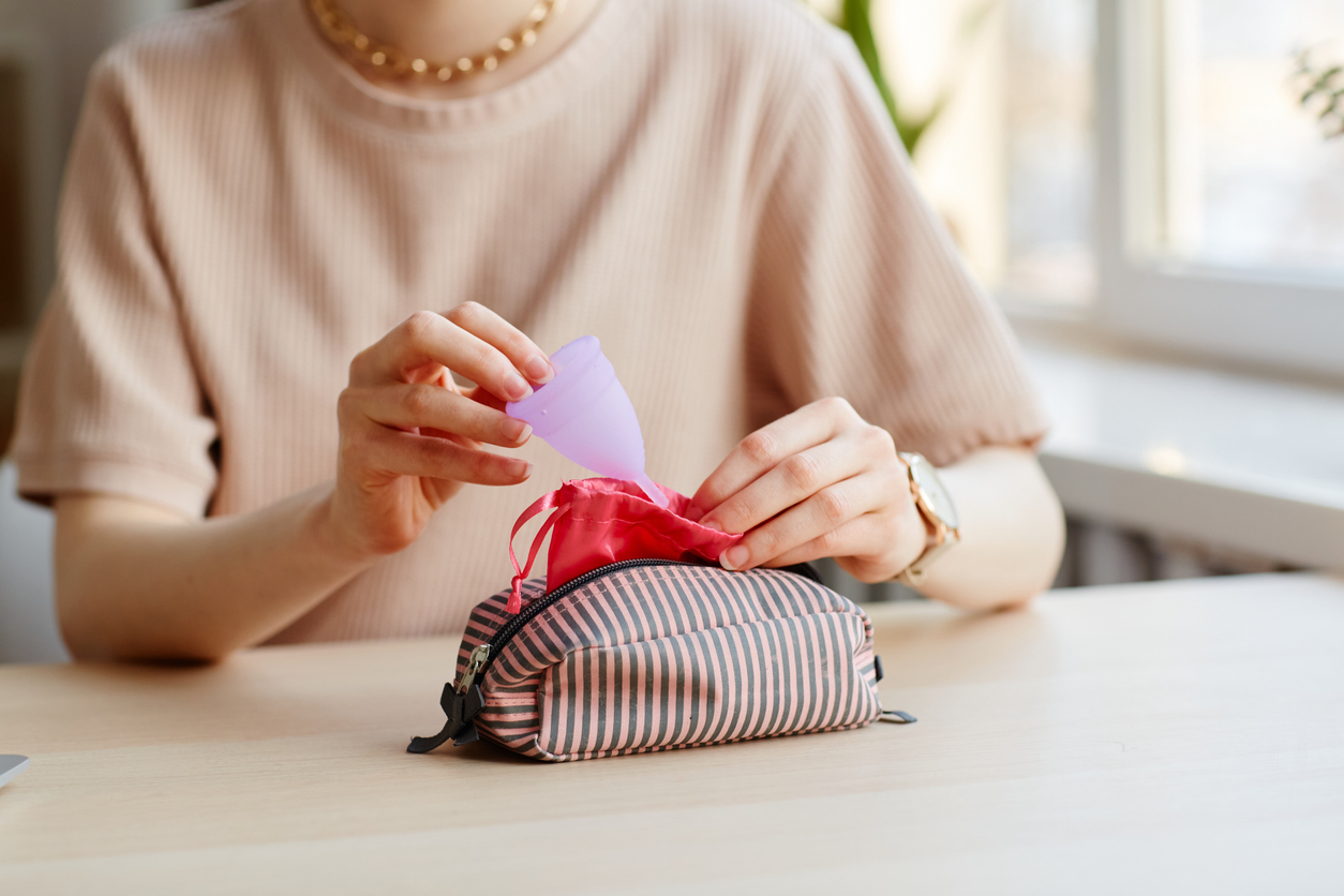 woman putting her menstrual cup away