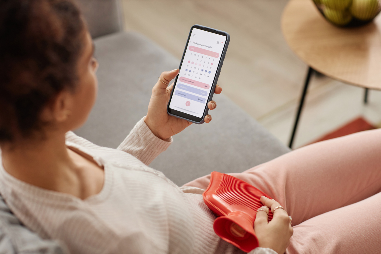 woman using a period tracker app