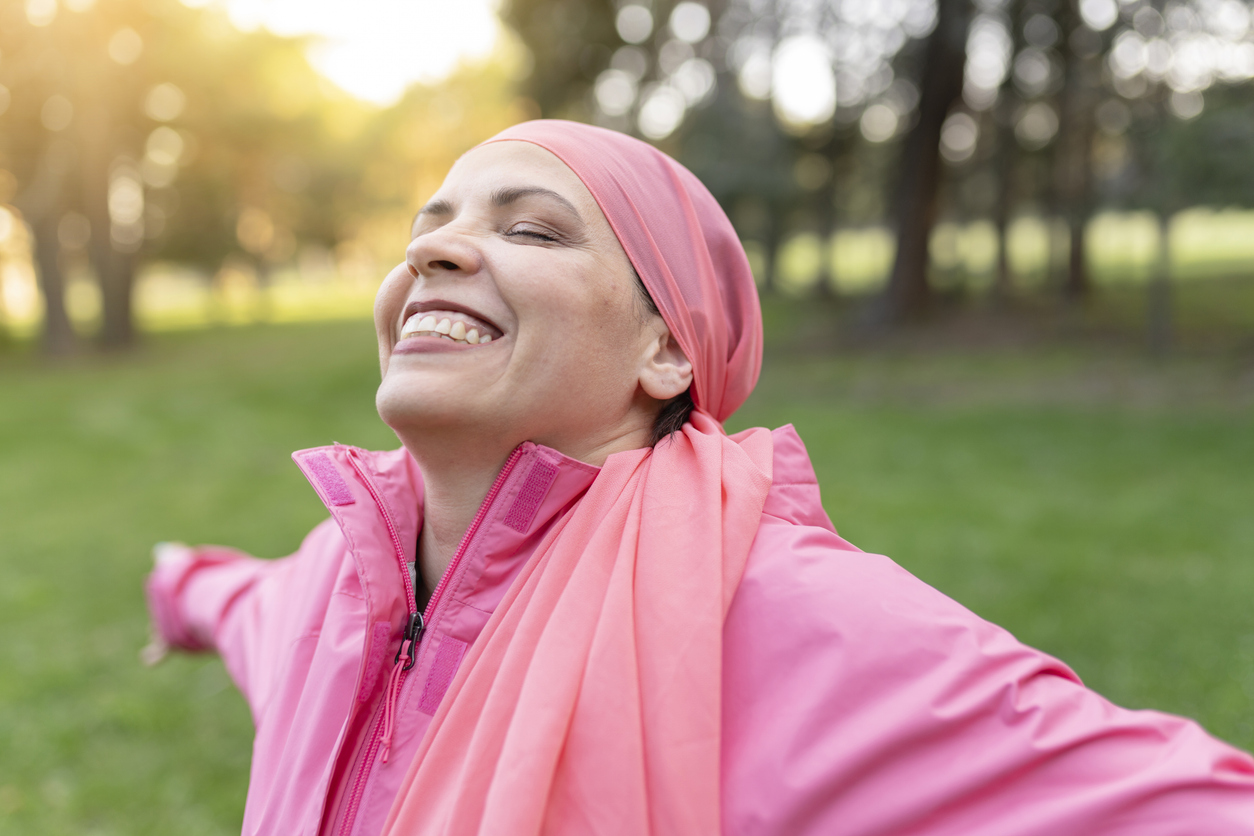 woman with cancer wearing all pink and basking in the sun