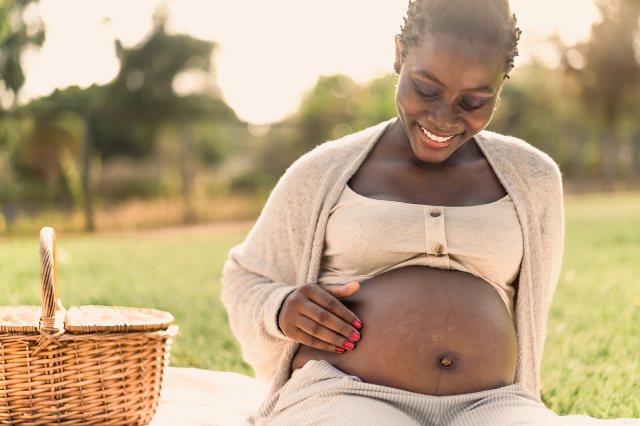 woman staring down at her pregnancy belly line