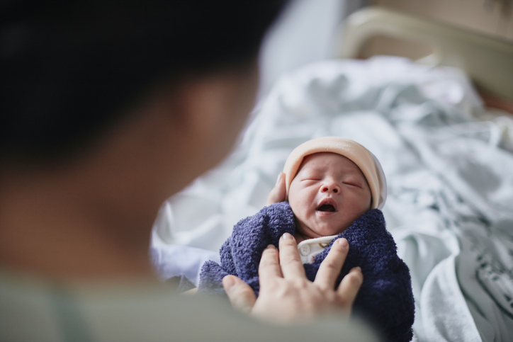 woman over 40 holding her newborn baby