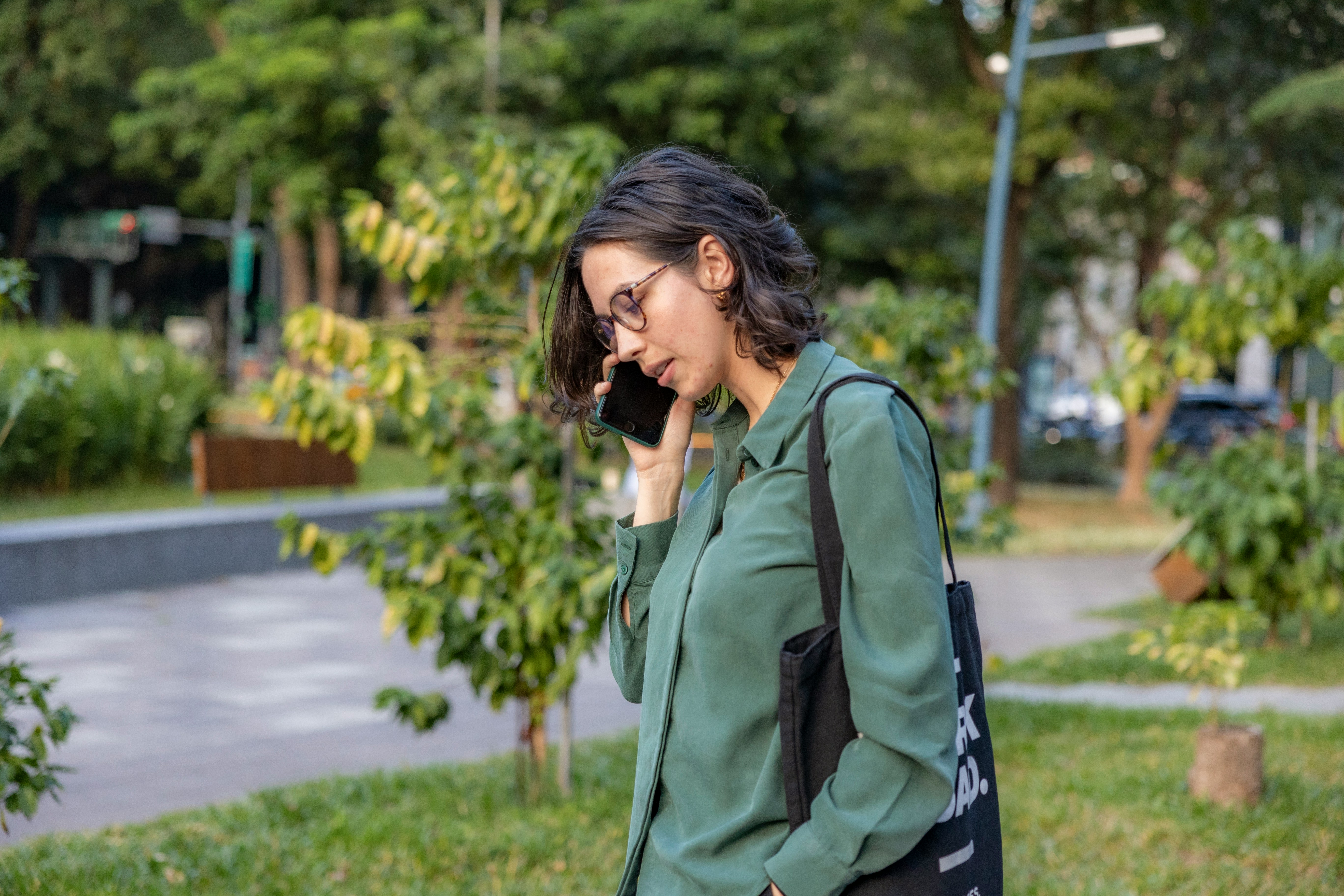 woman talking on the phone while walking outside