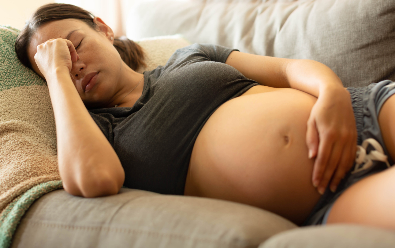 woman suffering from a migraine during pregnancy