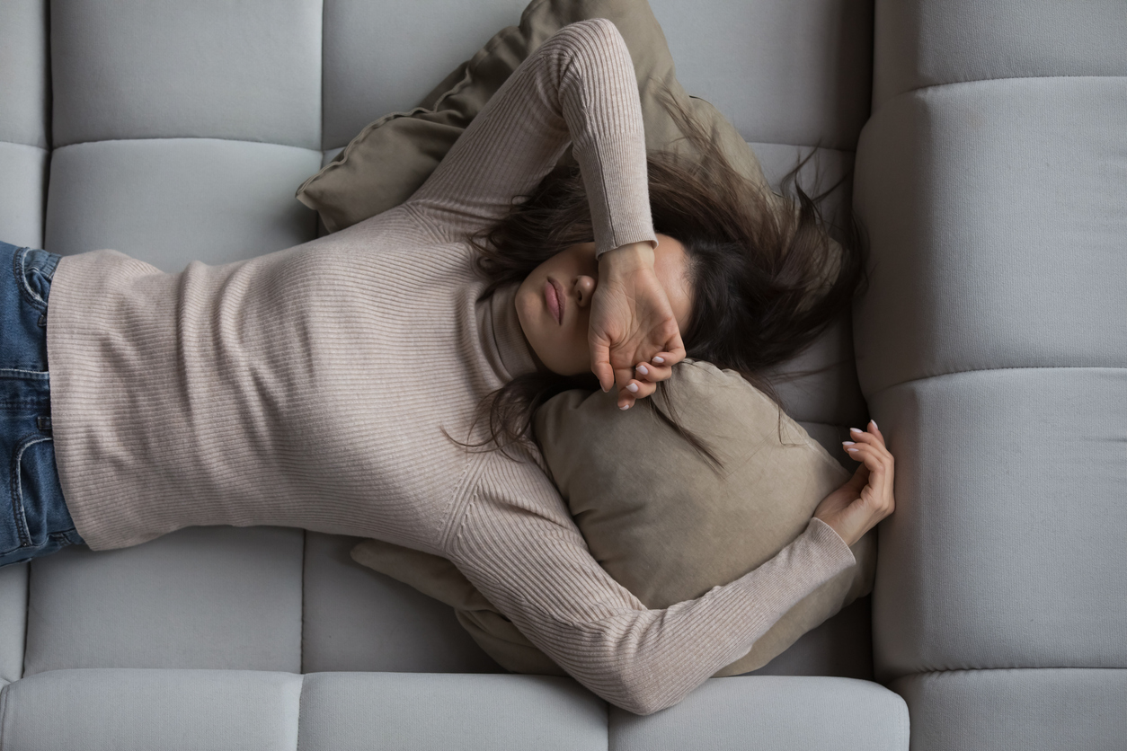 exhausted woman covering her eyes