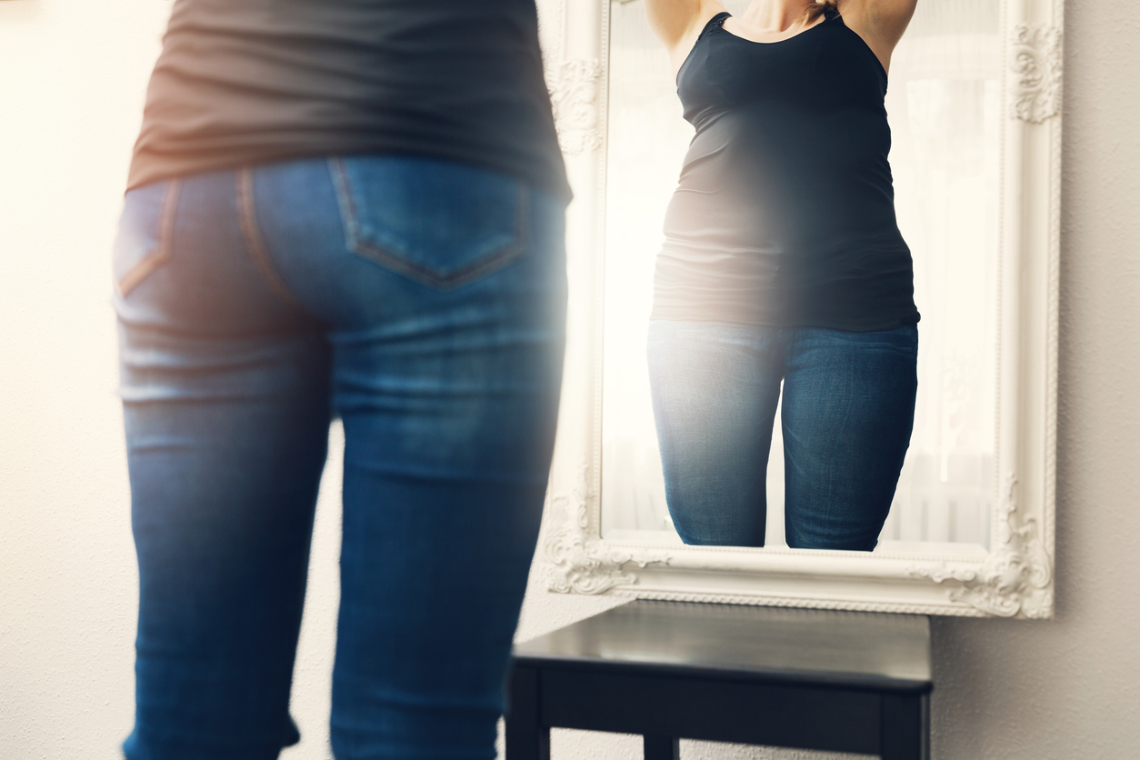 woman looking at herself in the mirror