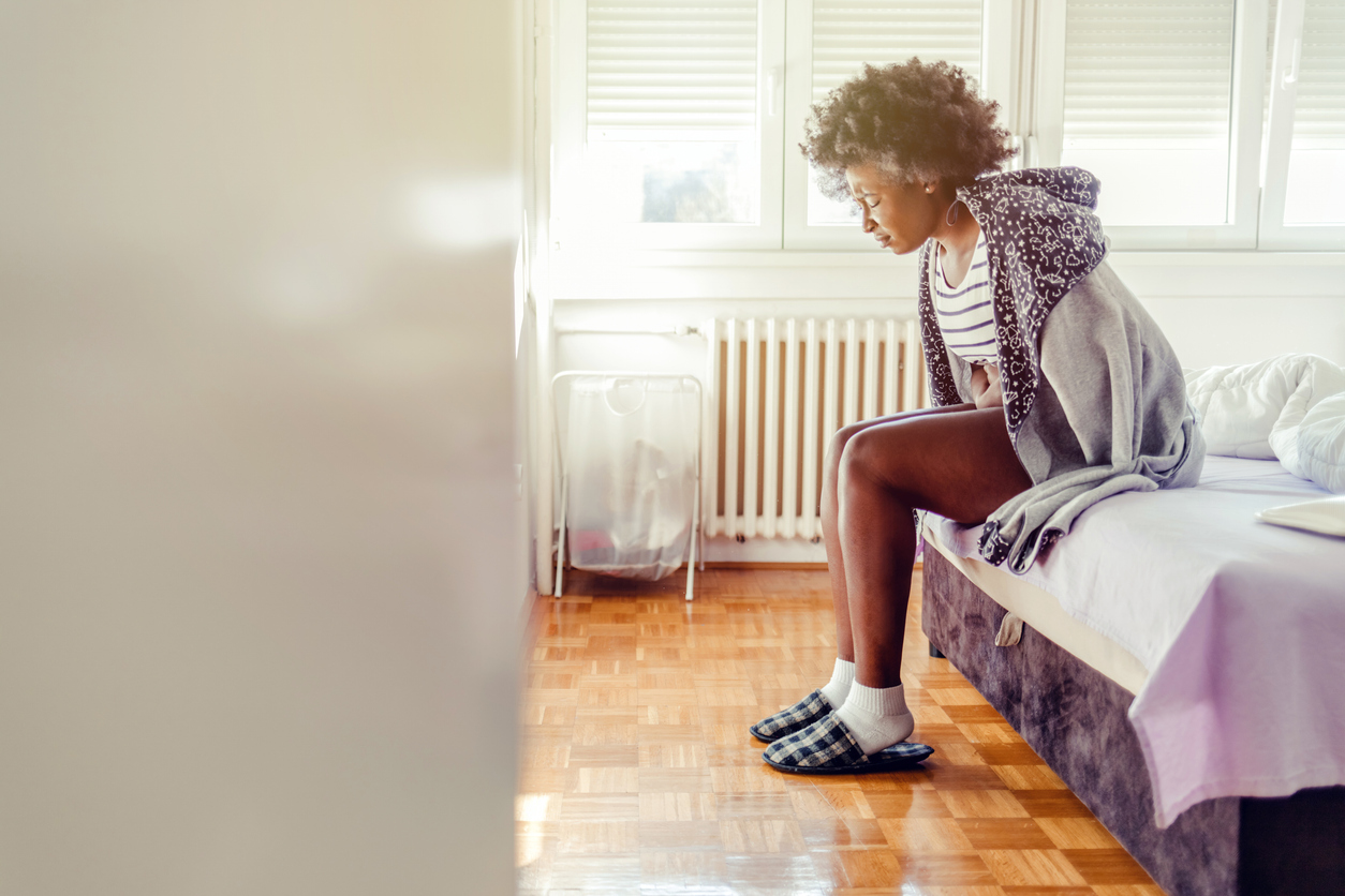 woman doubled over with pain due to endometriosis