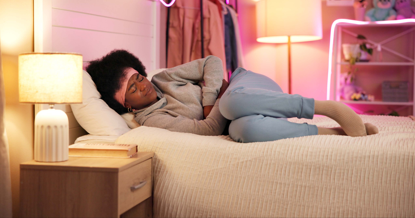 woman in bed struggling with endometriosis pain