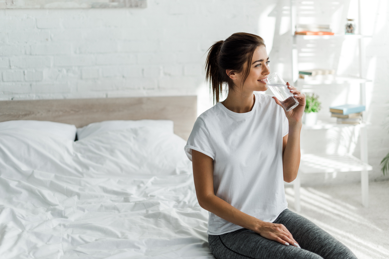 woman drinking a glass of water