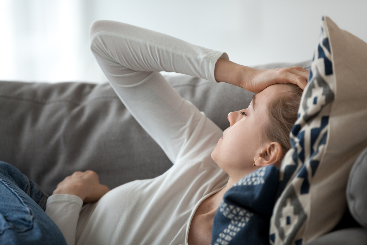 woman having a hormonal migraine