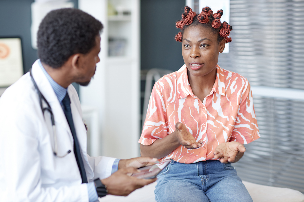 woman talking to her doctor about chronic migraines