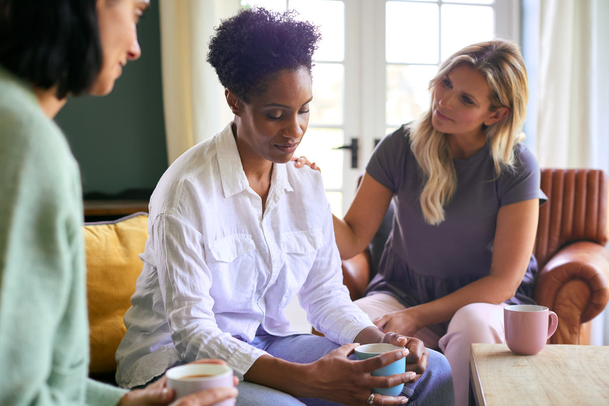 woman grieving a miscarriage with her friends