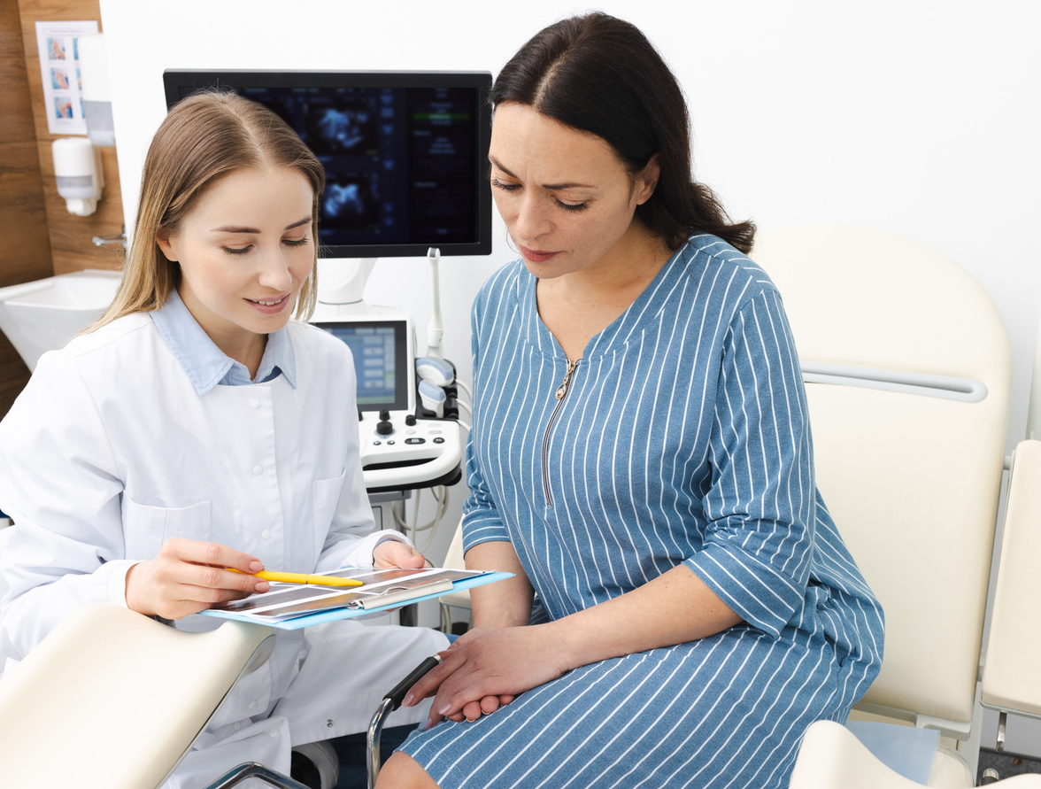 doctor showing a patient the results of her ultrasound