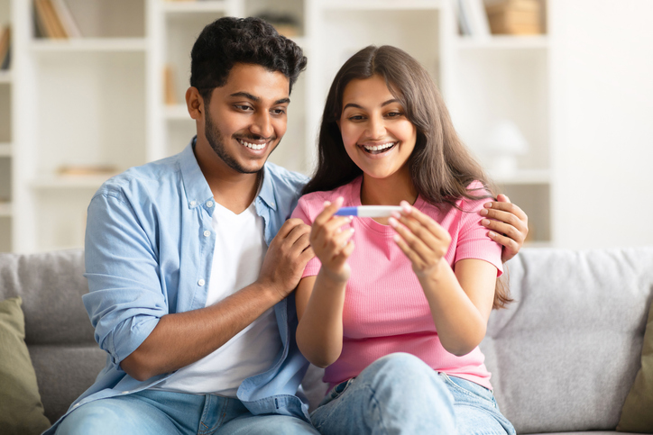 couple celebrating a positive pregnancy test result