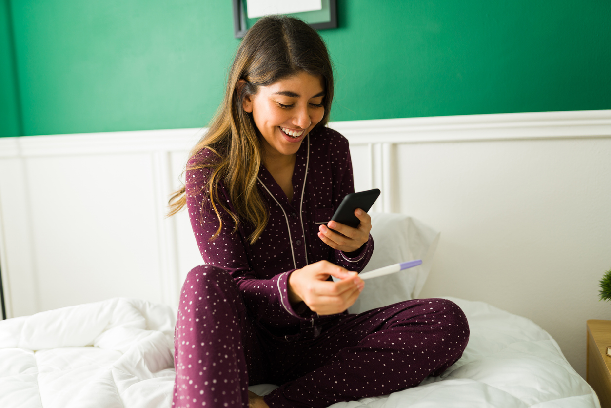 woman smiling at something on her phone