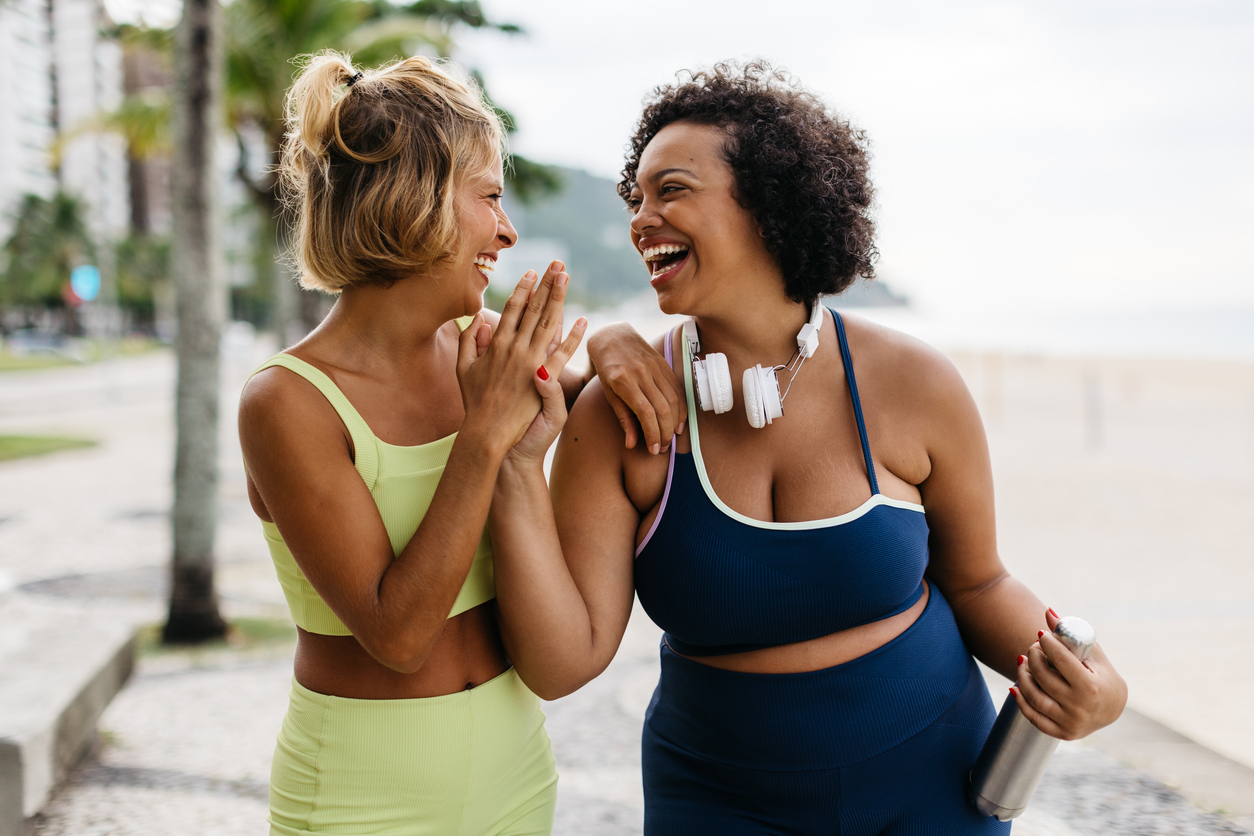 woman enjoying exercising outdoors together