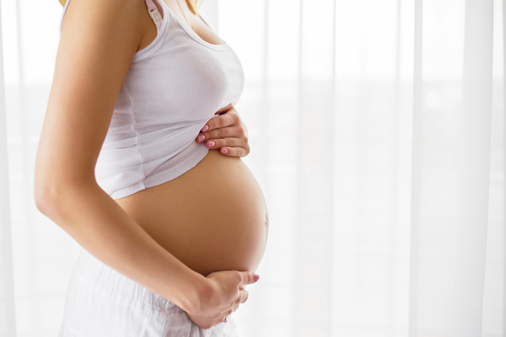 surrogate holding her baby bump