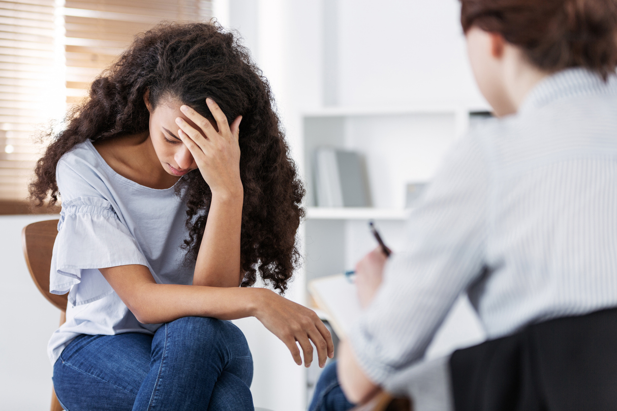 woman talking with psychologist about ptsd