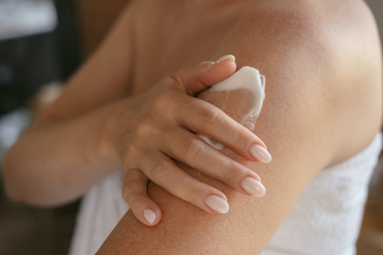 woman using a soothing cream on itchy skin