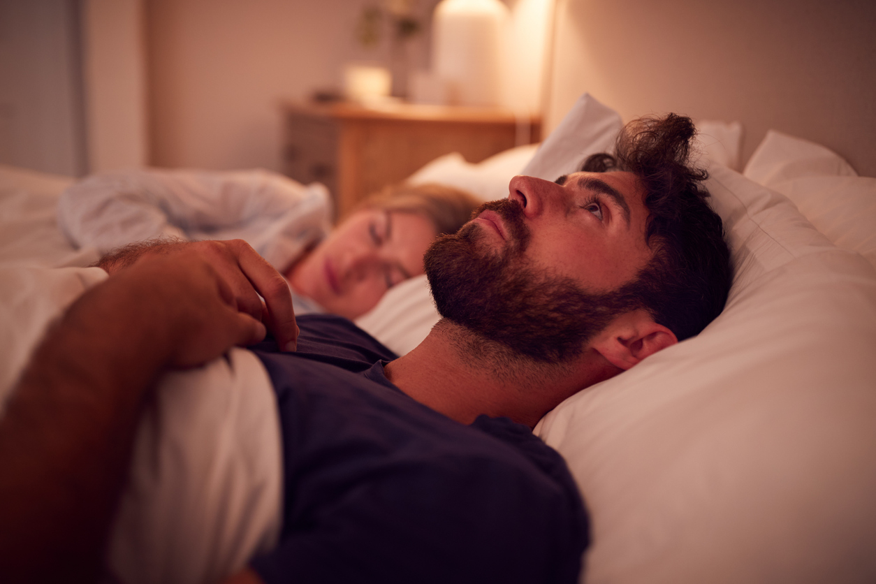 man wide awake in bed