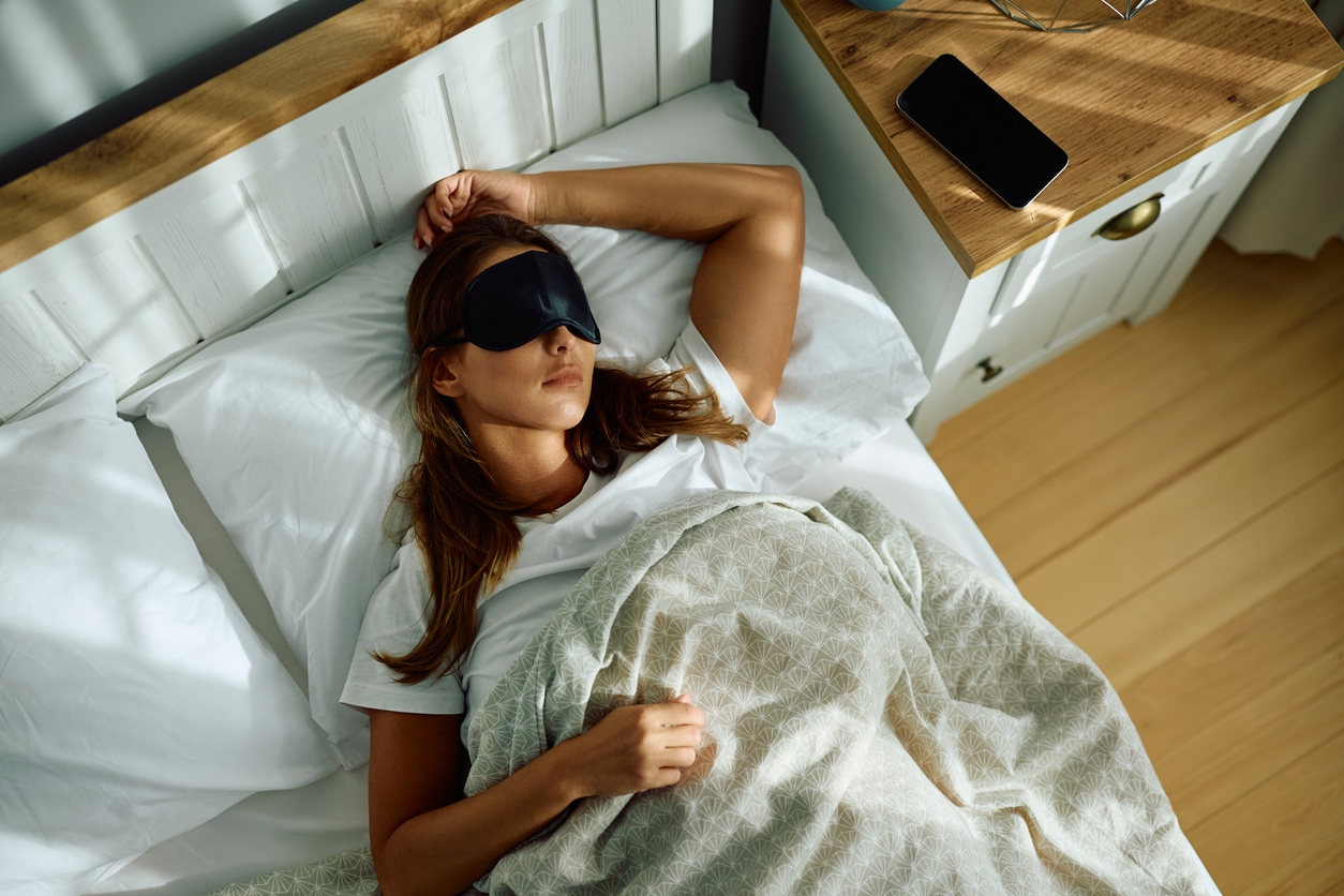 woman sleeping in the daylight with an eye mask on