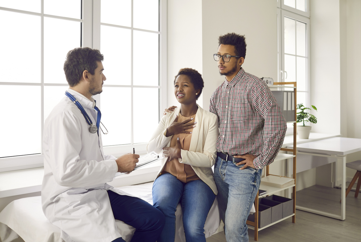 fertility specialist discussing embryglue pros and cons with a couple