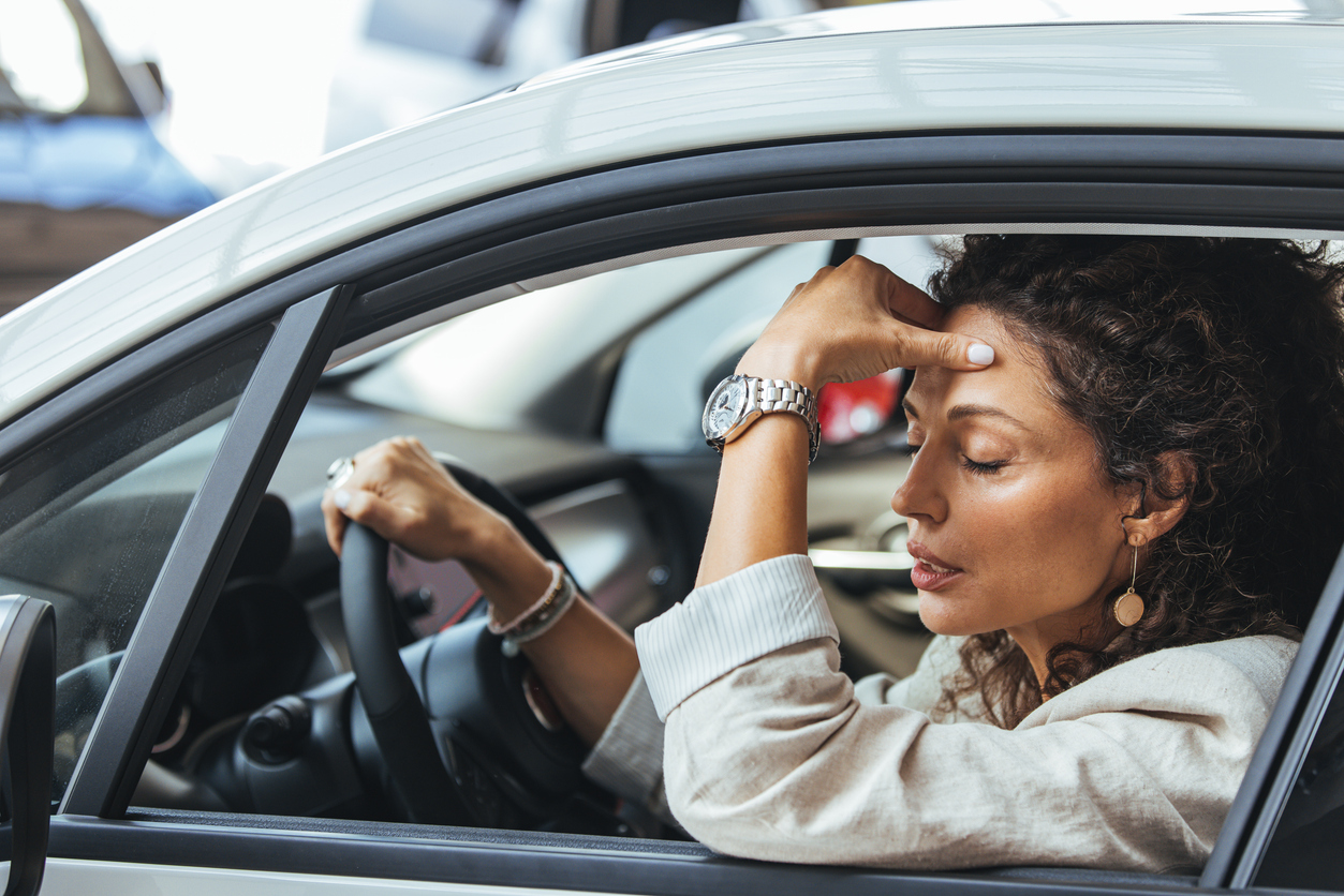 woman struggling with motion sickness while driving