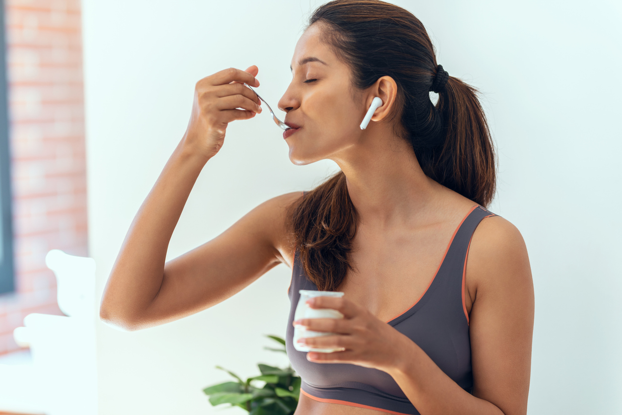 woman eating yogurt sweetened with stevia