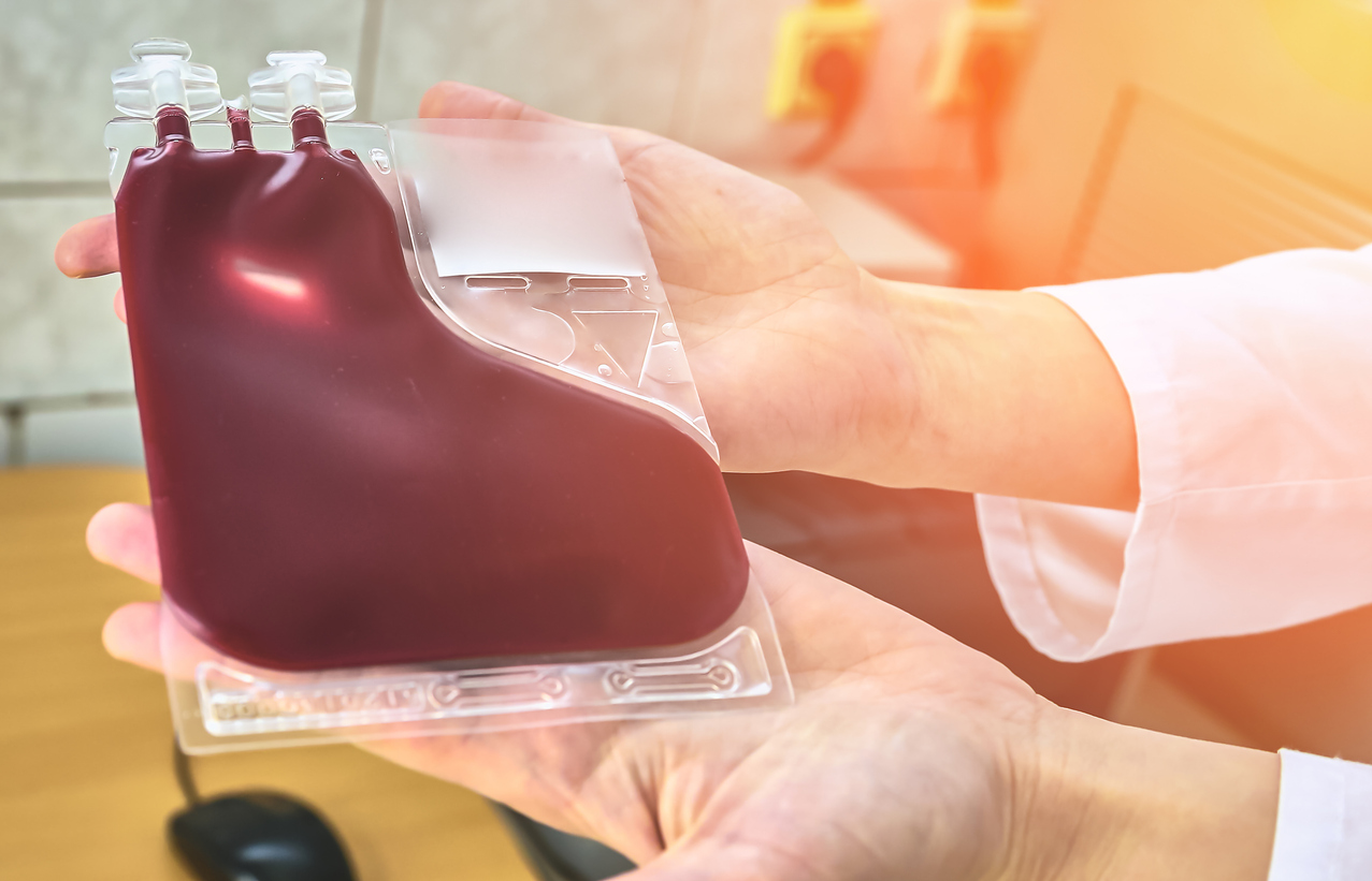 woman holding a liter of blood