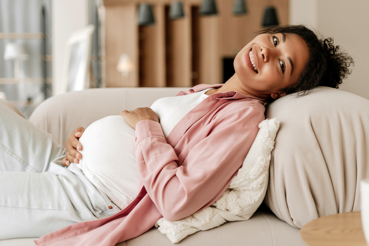 pregnant woman holding her baby bump