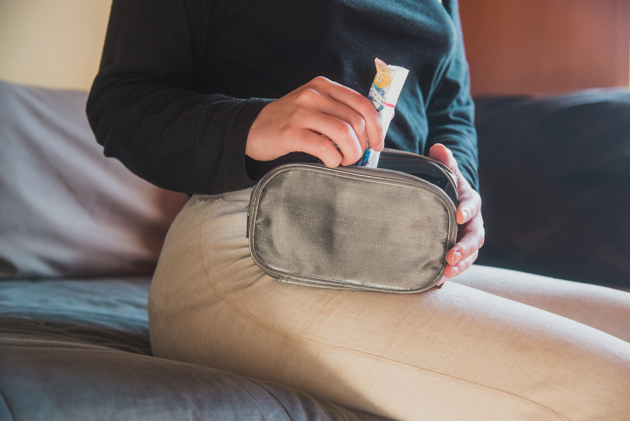 woman slipping a tampon in her purse