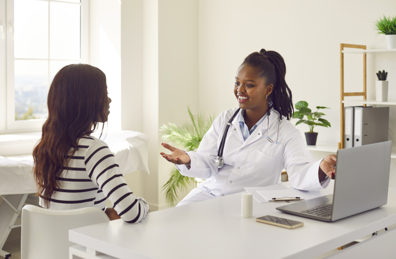 woman consulting her obgyn about cramps but no period
