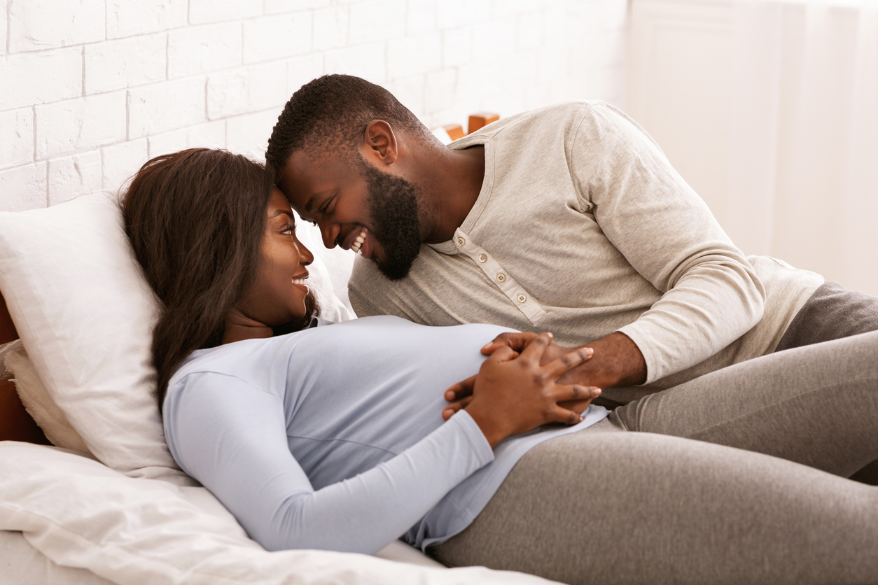 pregnant couple getting busy in bed