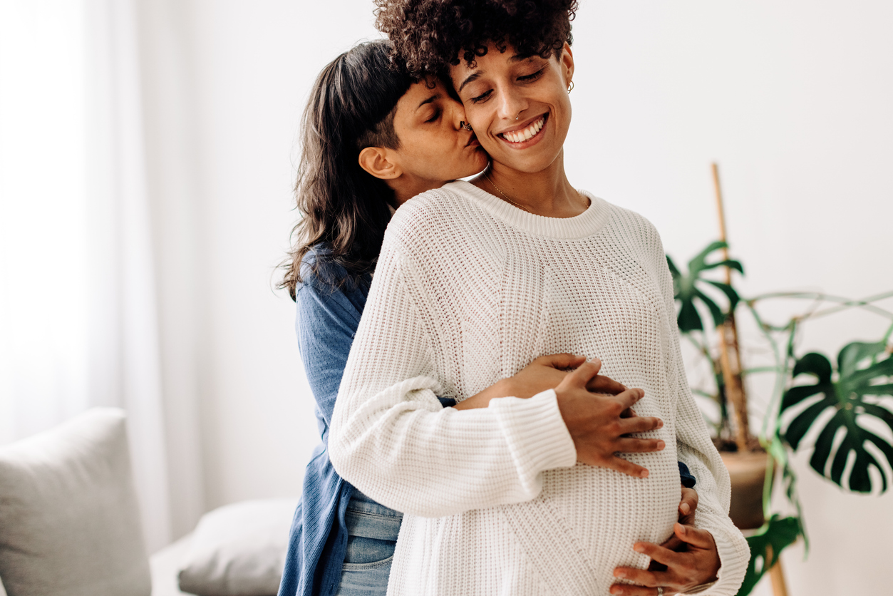 pregnant couple embracing