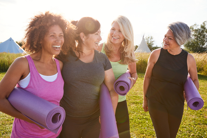 group of perimenopausal women walking to yoga
