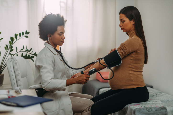 woman having her blood pressure checked during pregnancy