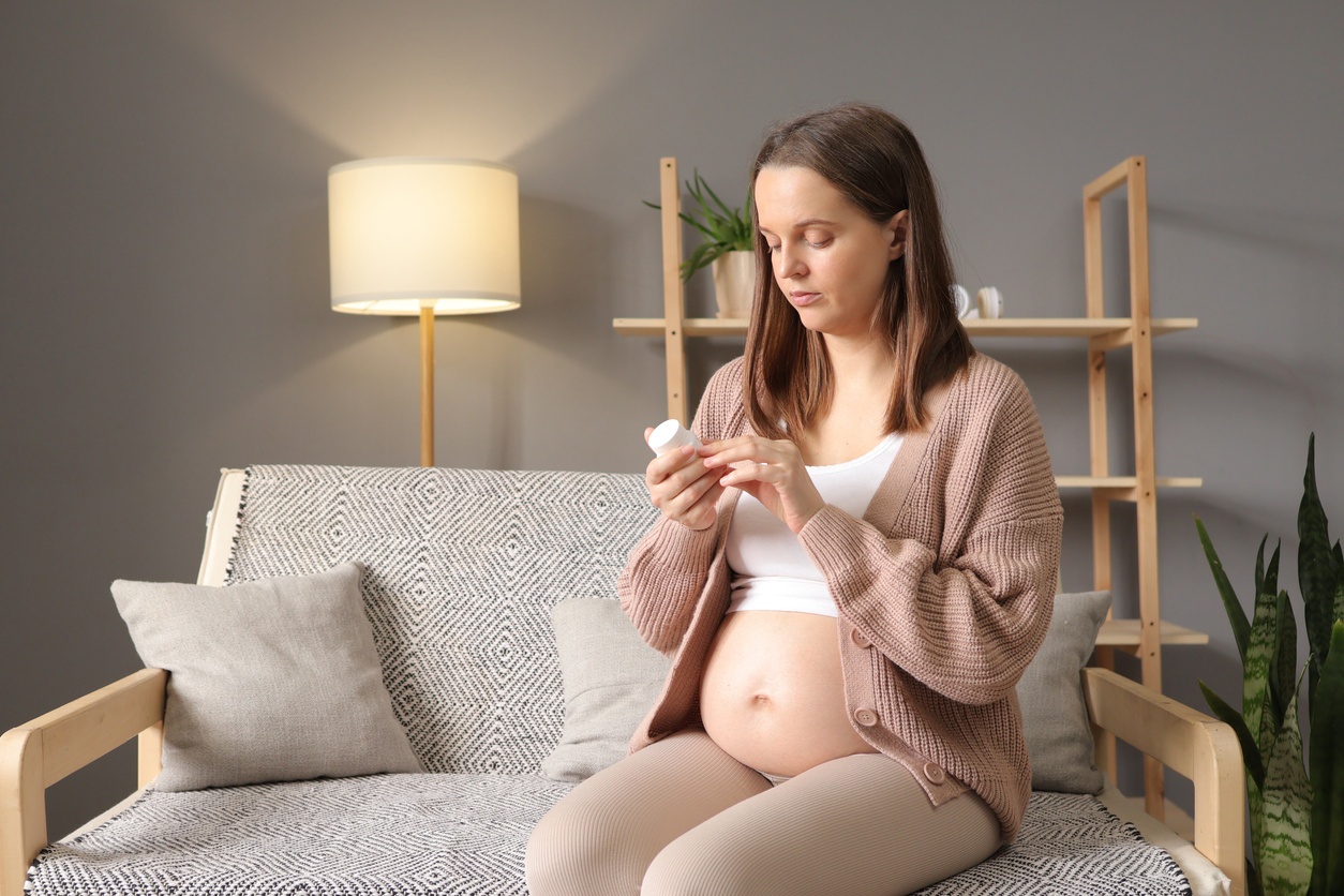 pregnant woman reading the fine print on her antibiotics