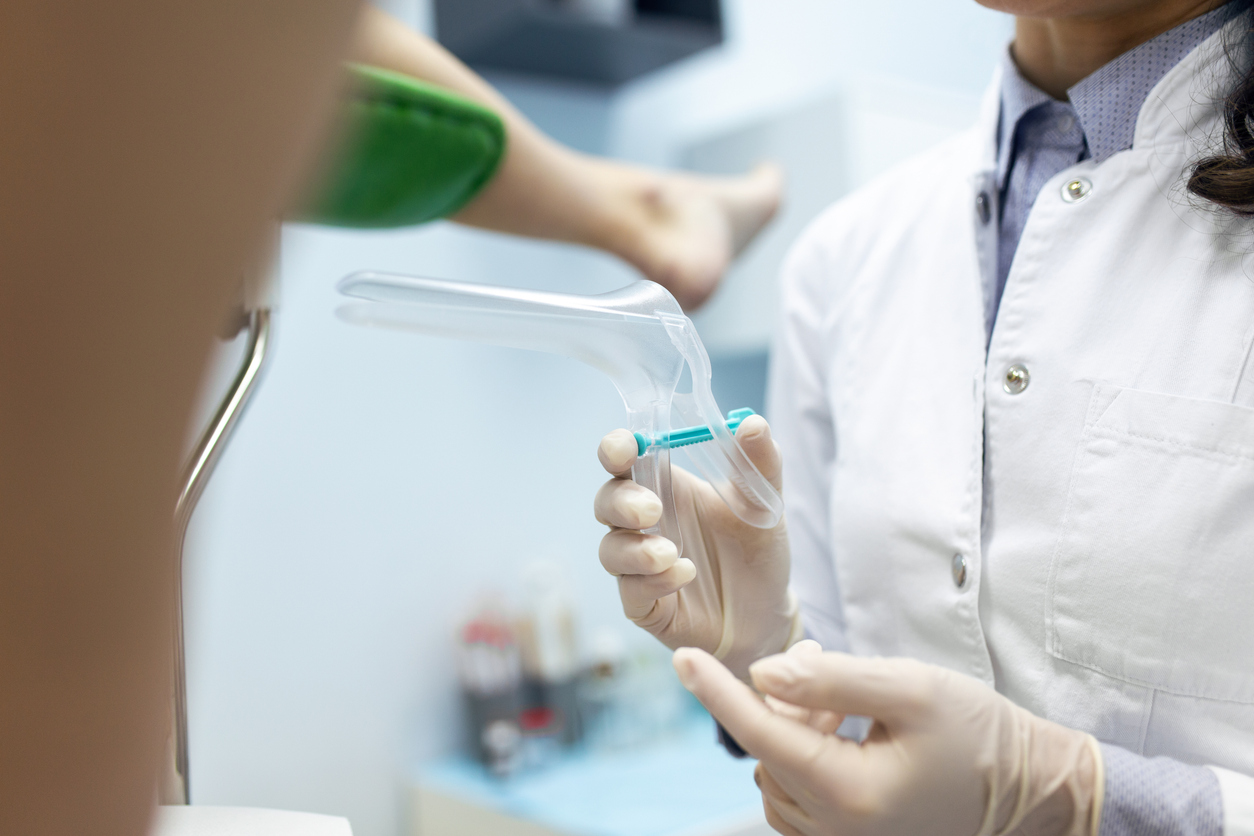 obgyn holding a speculum for a pap smear