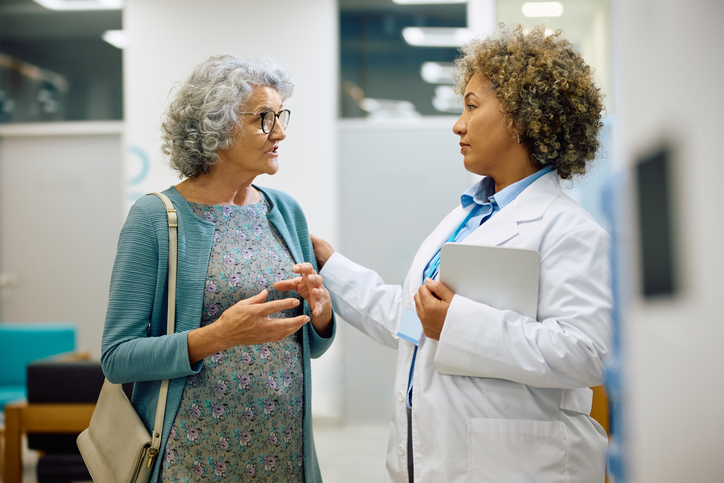 doctor talking with older female patient
