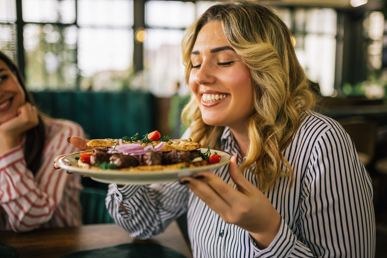woman eating a meal with foods that contain coq10