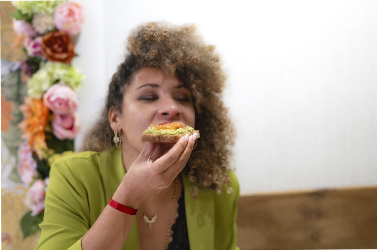 woman eating avocado toast high in coq10