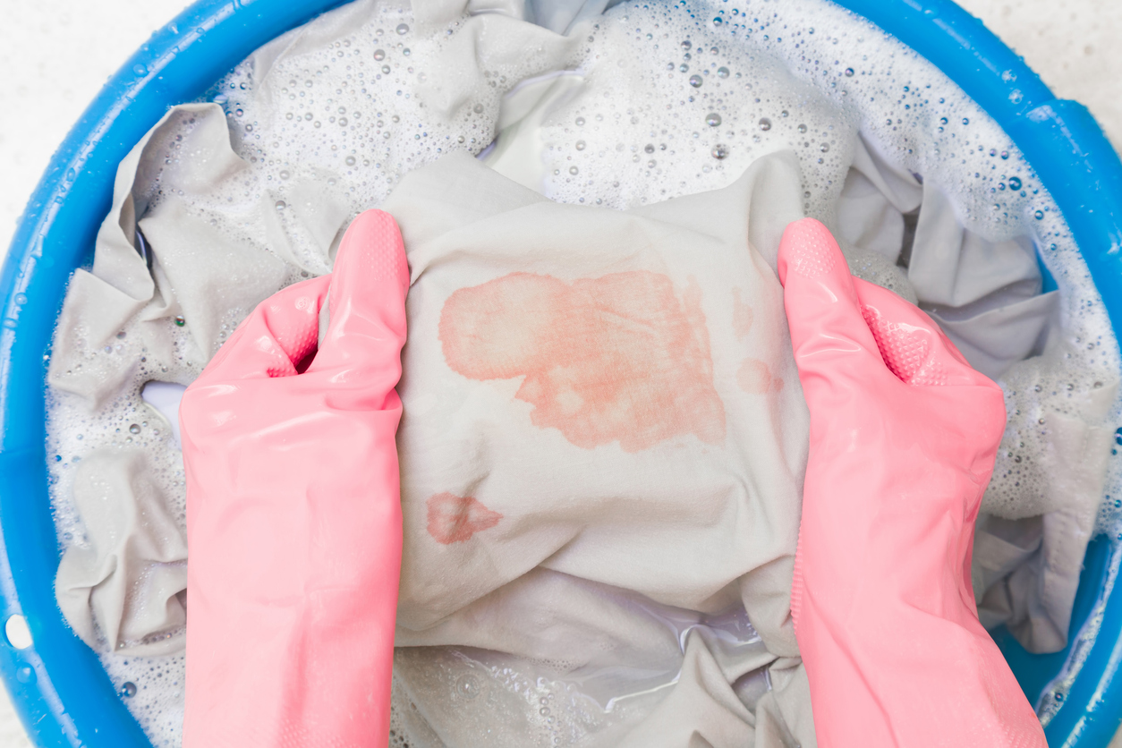 woman cleaning period stained underwear