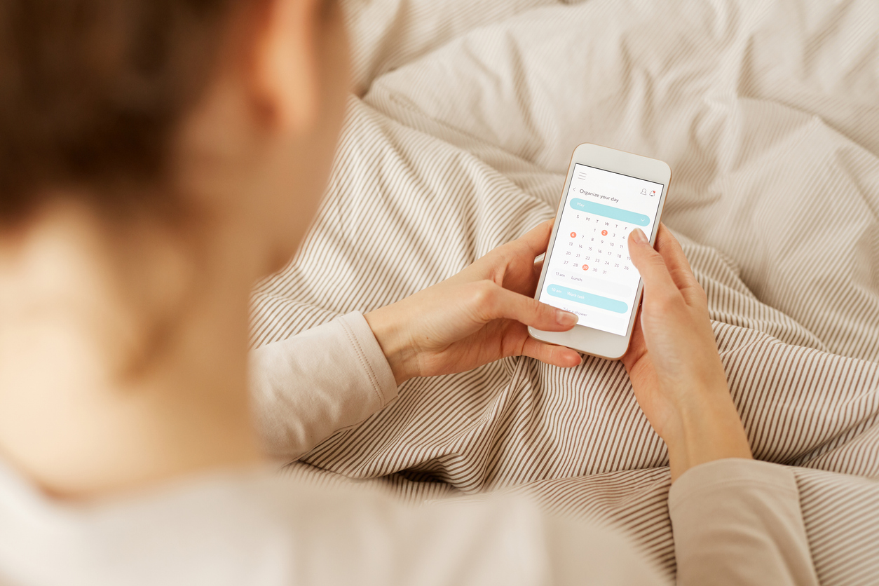 woman using a period tracker app