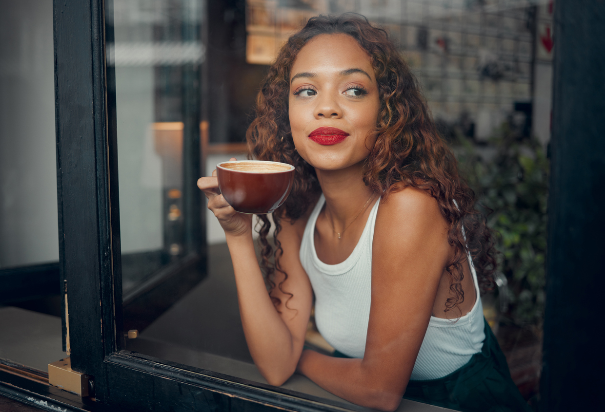 woman with a cup of coffee smiling