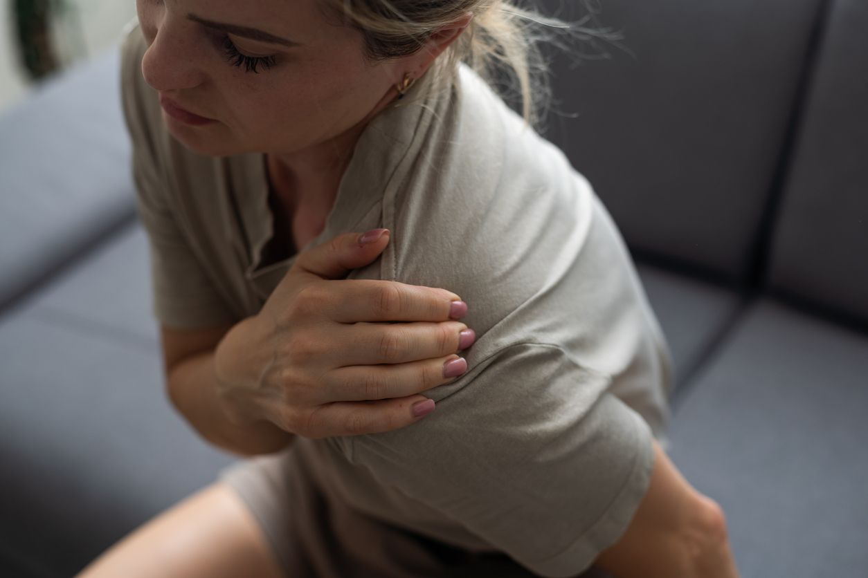 middle-aged woman waking up to frozen shoulder