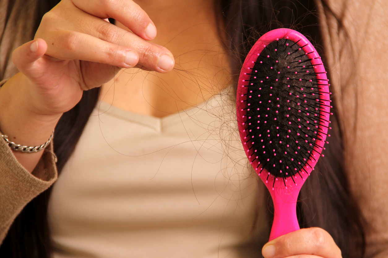 woman having postnatal hair loss